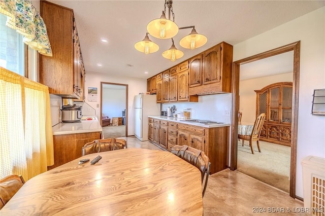 kitchen with a chandelier, hanging light fixtures, and white appliances