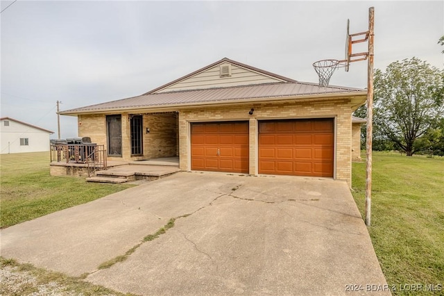 view of front of home featuring a wooden deck, a front yard, and a garage