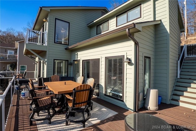 exterior space with a wooden deck and a balcony