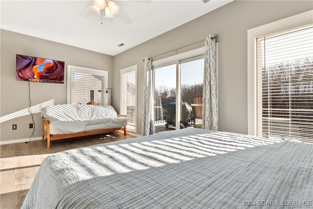 bedroom featuring hardwood / wood-style floors, ceiling fan, and access to exterior