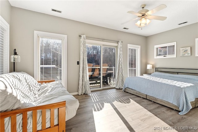 bedroom with access to exterior, wood-type flooring, and ceiling fan