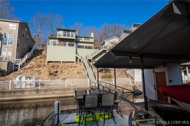 view of patio with a dock and a water view