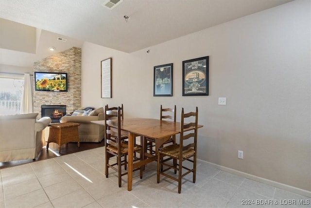 4800 Eagleview Dr Unit 241A, Osage Beach, MO 65065 - dining space with vaulted ceiling, light tile patterned floors, and a fireplace