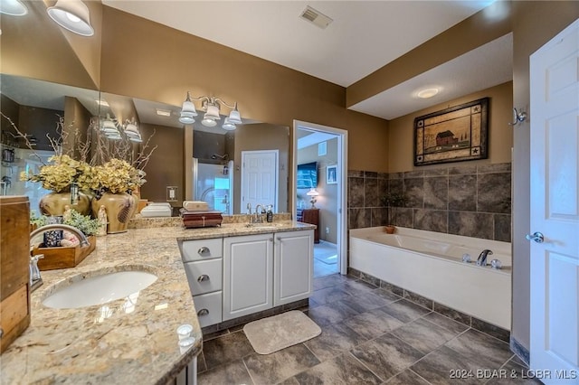 bathroom featuring vanity and independent shower and bath