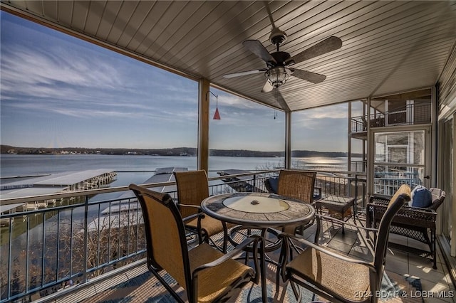 exterior space with a water view and ceiling fan