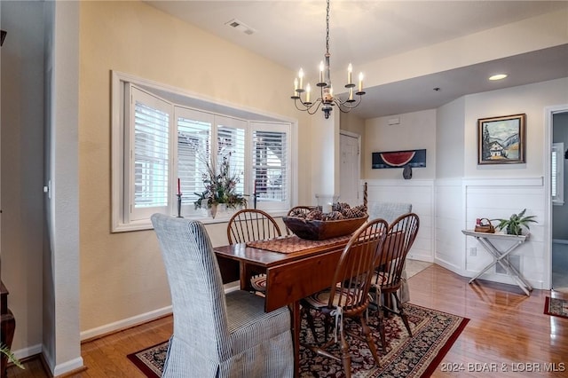 dining space featuring a chandelier and hardwood / wood-style flooring