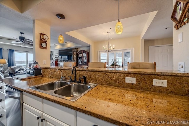 kitchen featuring ceiling fan with notable chandelier, sink, dishwasher, white cabinetry, and hanging light fixtures