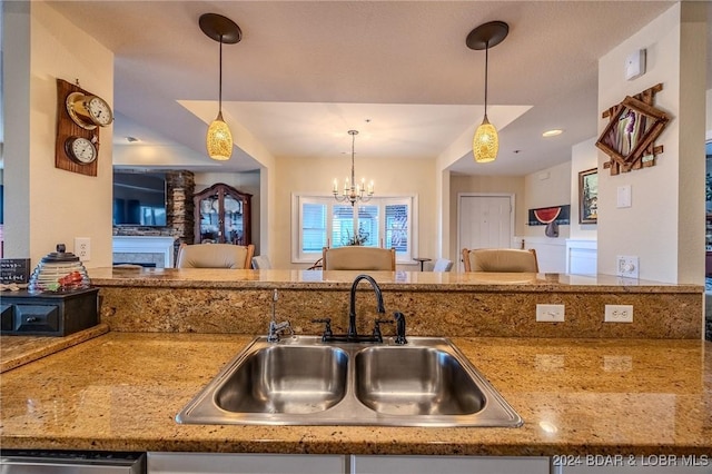 kitchen with dishwasher, decorative light fixtures, a notable chandelier, and sink