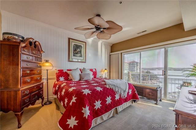 carpeted bedroom with ceiling fan and access to exterior