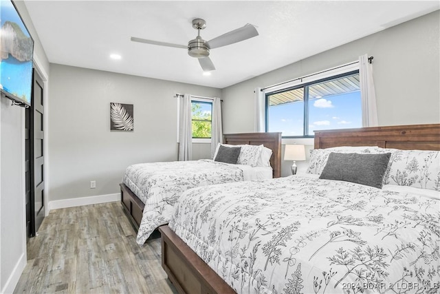 bedroom featuring ceiling fan and light hardwood / wood-style floors