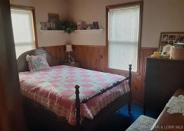 bedroom with wooden walls