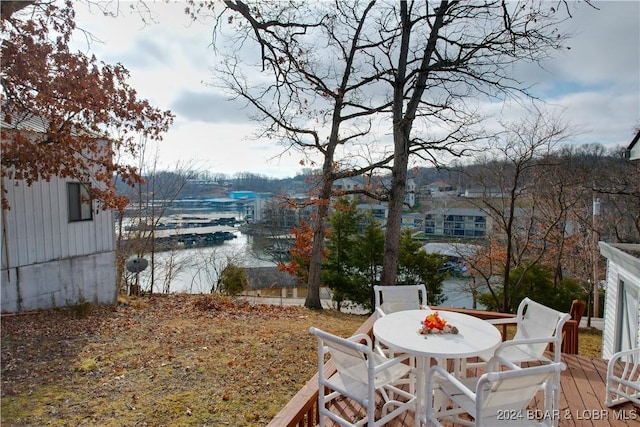 view of yard with a deck with water view