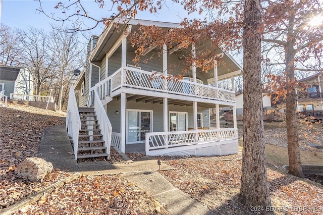 view of front of property featuring covered porch and a balcony