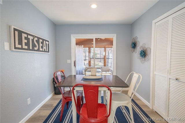 dining space with hardwood / wood-style floors