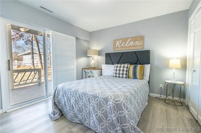 bedroom featuring access to outside and wood-type flooring