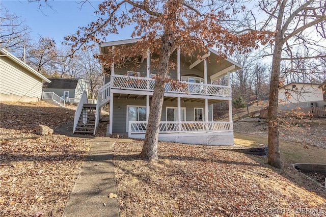 view of front of property with a balcony and a porch