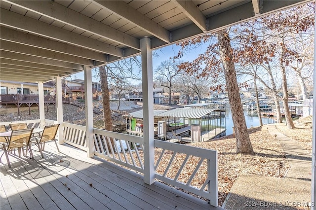 wooden terrace with a boat dock and a water view