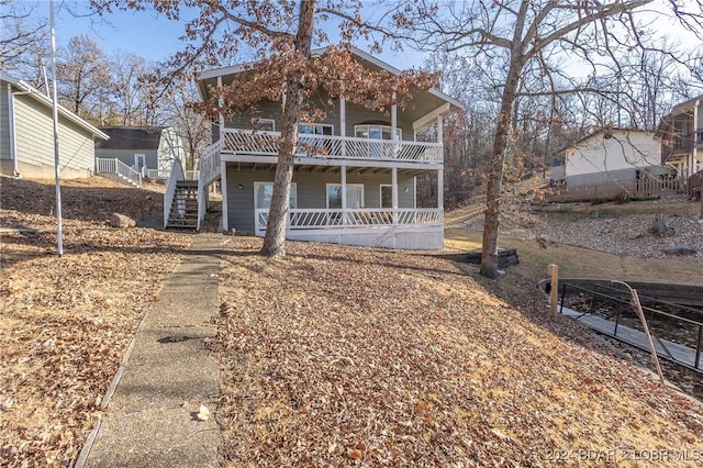 6455 Running Deer Dr, Osage Beach, MO 65065 - view of front facade with stairway, covered porch, and a deck