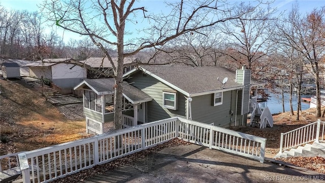 back of property with a sunroom