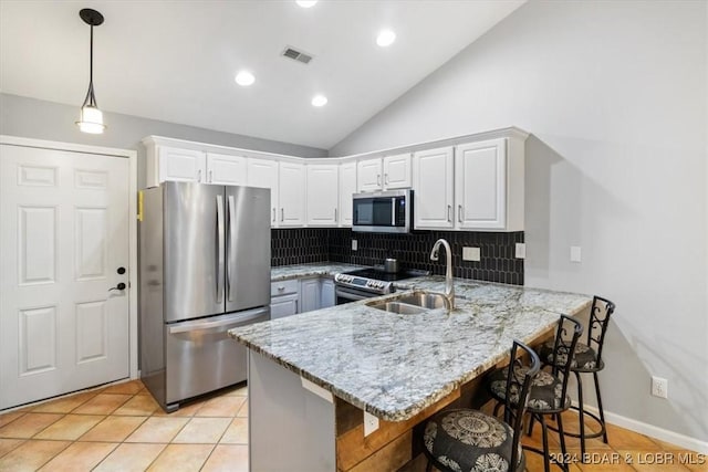 kitchen featuring kitchen peninsula, white cabinetry, sink, and stainless steel appliances