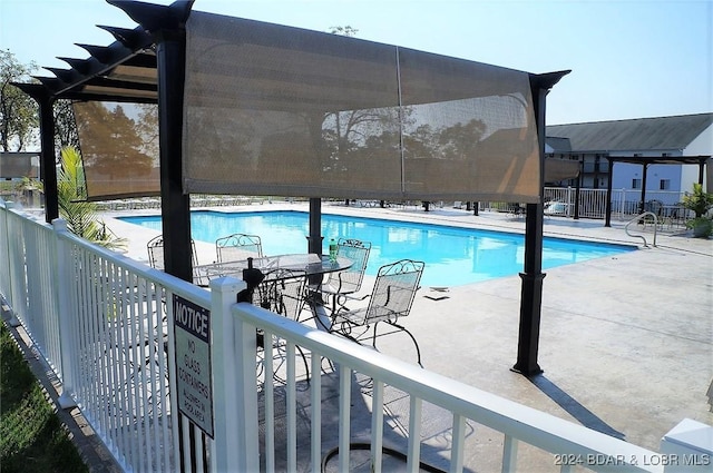 view of swimming pool with a patio area