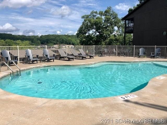 view of swimming pool with a patio area