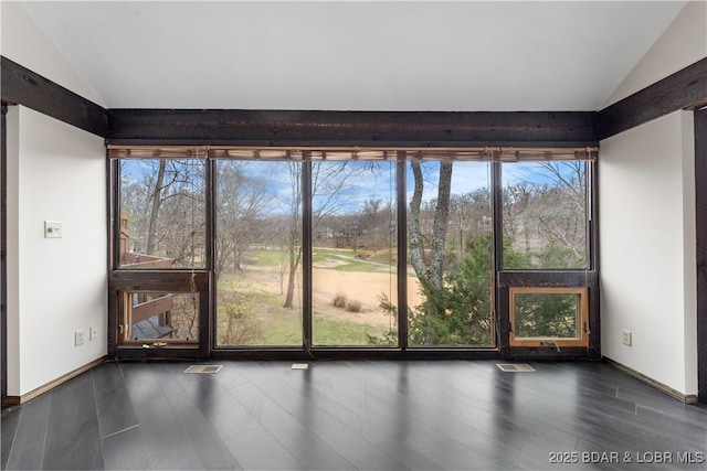 unfurnished sunroom featuring vaulted ceiling