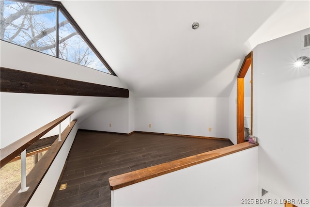 bonus room featuring dark wood-type flooring and vaulted ceiling