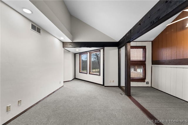 basement featuring wood walls and light carpet