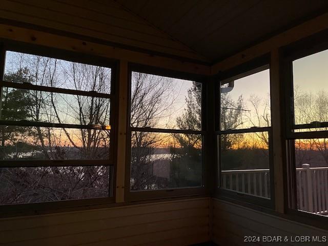 unfurnished sunroom with vaulted ceiling