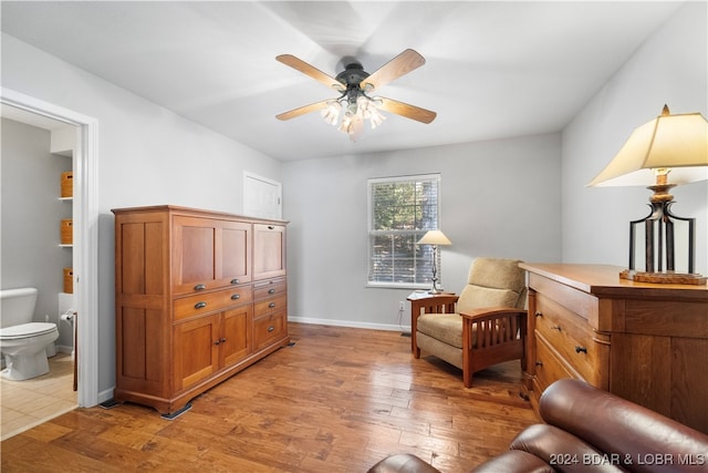 living area with light wood-type flooring and ceiling fan