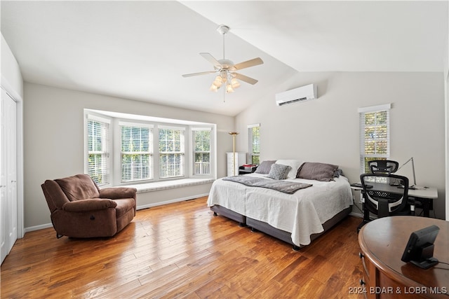 bedroom with wood-type flooring, a closet, an AC wall unit, and ceiling fan