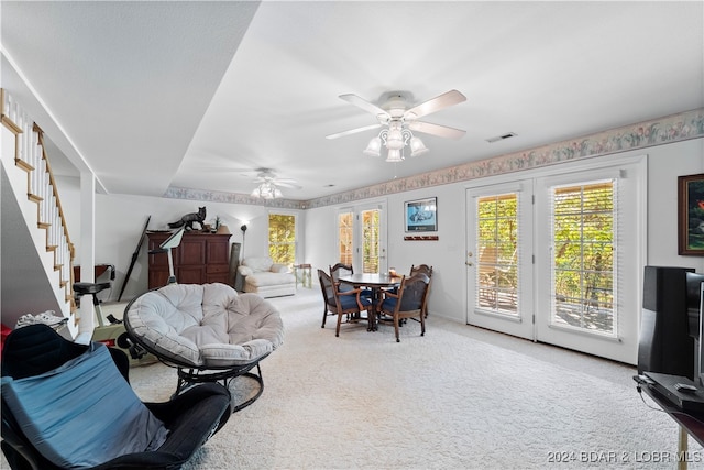 carpeted living room with ceiling fan