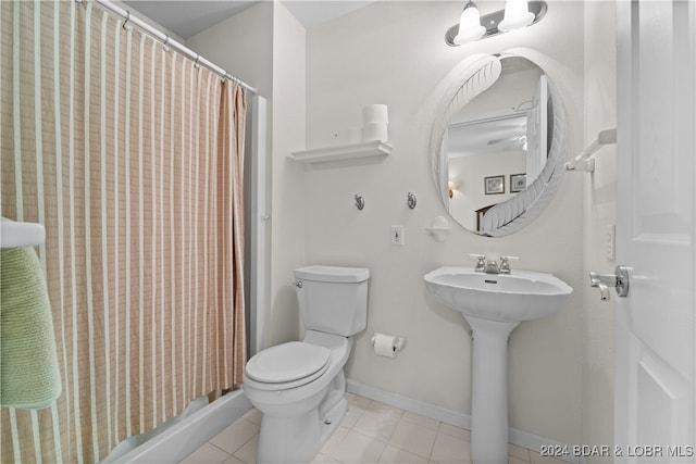 bathroom featuring tile patterned flooring, toilet, sink, and a shower with shower curtain