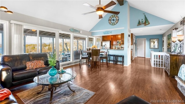 living room with dark hardwood / wood-style flooring, high vaulted ceiling, and ceiling fan