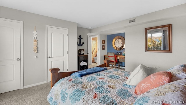 bedroom featuring light carpet and ensuite bathroom