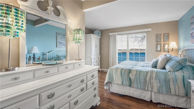 bedroom featuring a water view, dark hardwood / wood-style flooring, and beamed ceiling