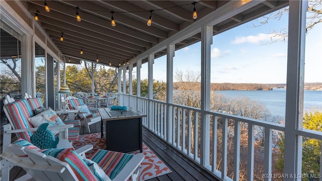 sunroom / solarium with a water view