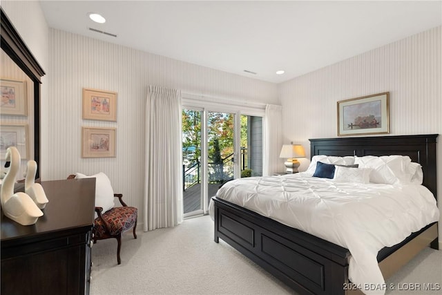 bedroom featuring light carpet and access to outside