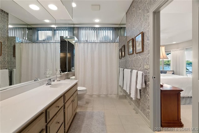 bathroom featuring tile patterned floors, vanity, and toilet