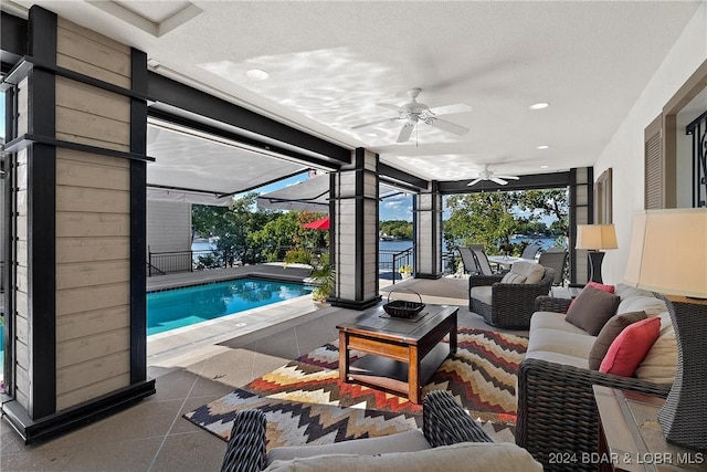 interior space featuring ceiling fan and a textured ceiling