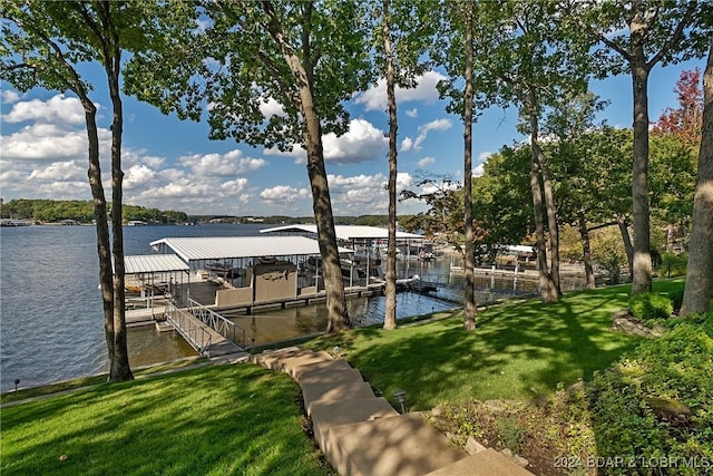 dock area with a water view and a lawn