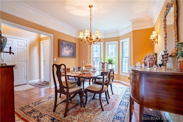 dining room featuring hardwood / wood-style flooring, crown molding, and a notable chandelier