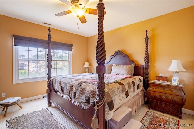 bedroom with ceiling fan and light carpet