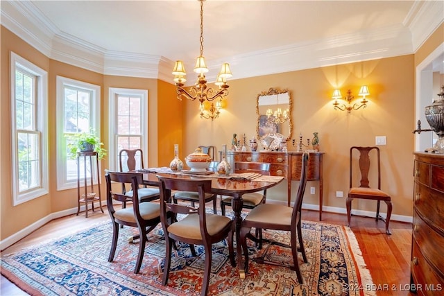 dining space featuring crown molding, hardwood / wood-style floors, and an inviting chandelier