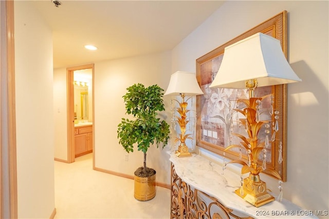 hall featuring light carpet, baseboards, and recessed lighting