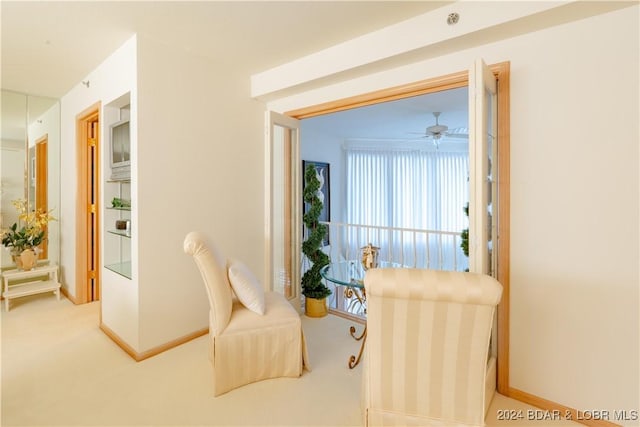 sitting room featuring carpet floors and baseboards