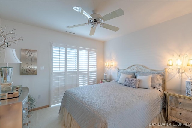 bedroom with ceiling fan and light colored carpet