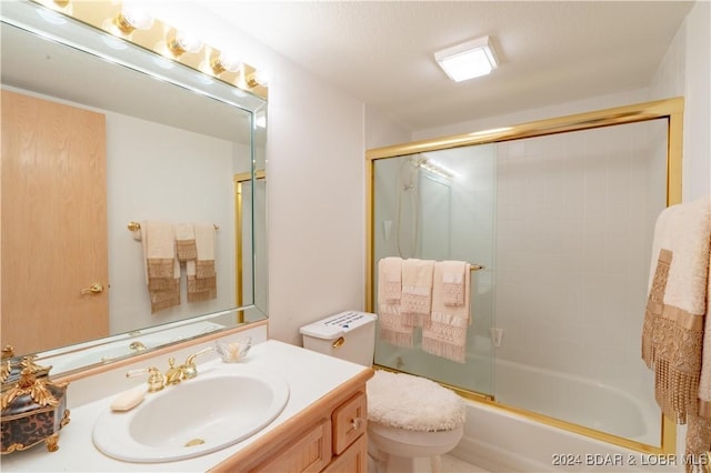 full bathroom with vanity, shower / bath combination with glass door, and toilet