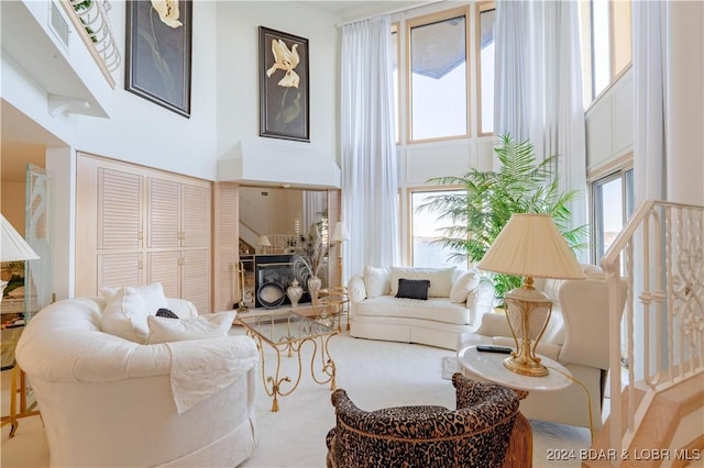 living room with a towering ceiling and plenty of natural light